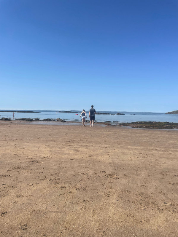 Gavin and little McGavin on the beach, walking towards the sea
